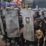 In the video, how Orban greets Kosovo Serb protesters