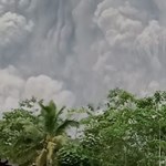 People emerge from a large ash cloud of an Indonesian volcano - video